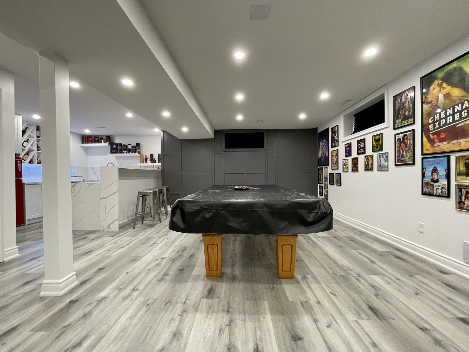 Basement entertainment room with bar and pool table